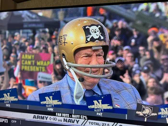 Bill Belichick wears a 1962 Navy helmet, complete with its own version of the ‘Jolly Roger,’ to make his guest pick for the Army-Navy game at Gillette Stadium.